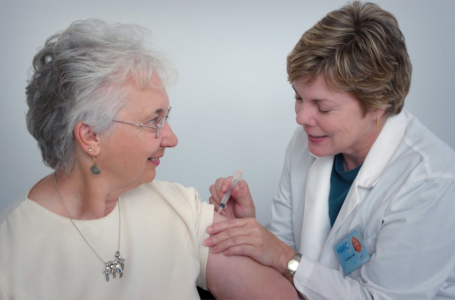A doctor caring for an older woman in a clinic