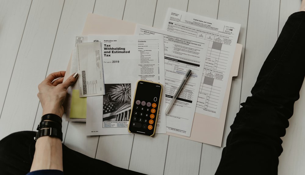 Invoices, a calculator and a phone on a desk